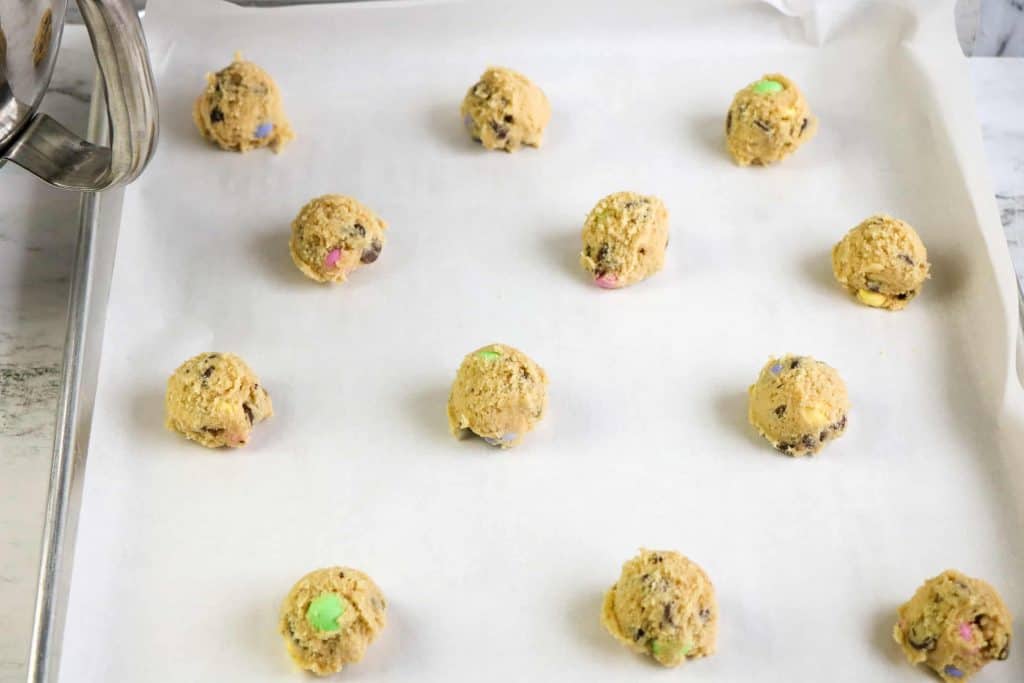 Easter M and M cookie dough on a sheet pan.