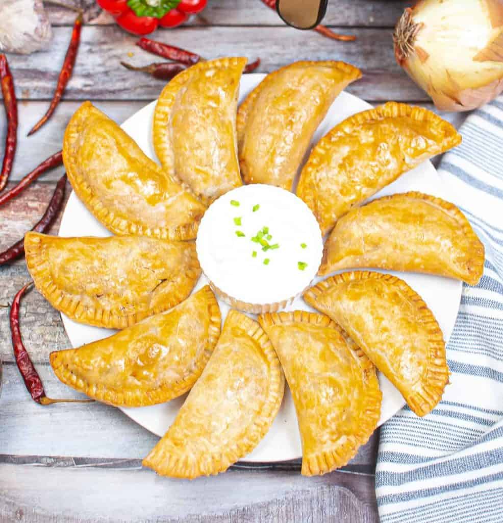 Overhead view of air fryer empanadas.