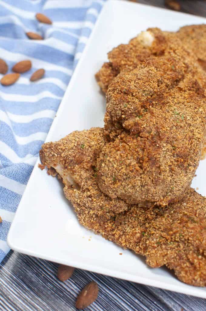 Almond crusted chicken on a white plate.