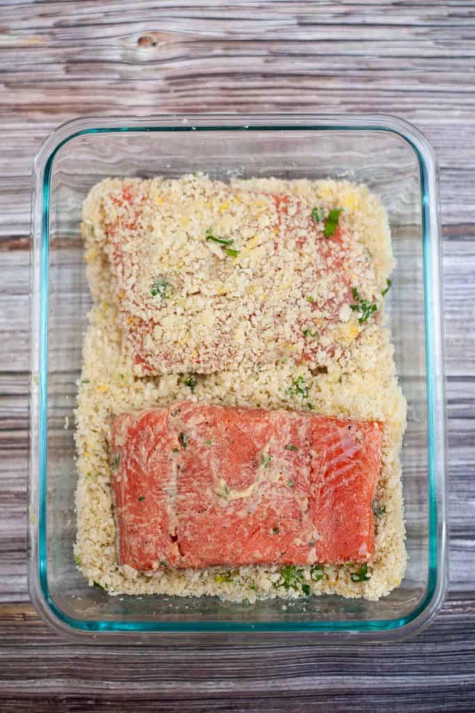 Dredging salmon in bread crumbs.