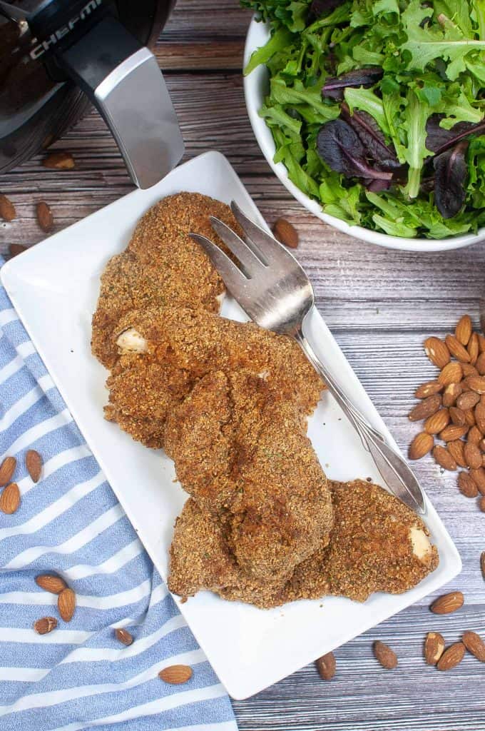 Overhead view of air fryer almond crusted chicken