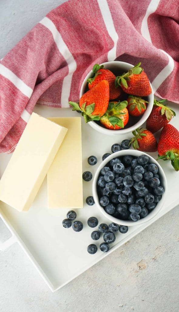 Overhead view of strawberries, blueberries and white cheddar cheese