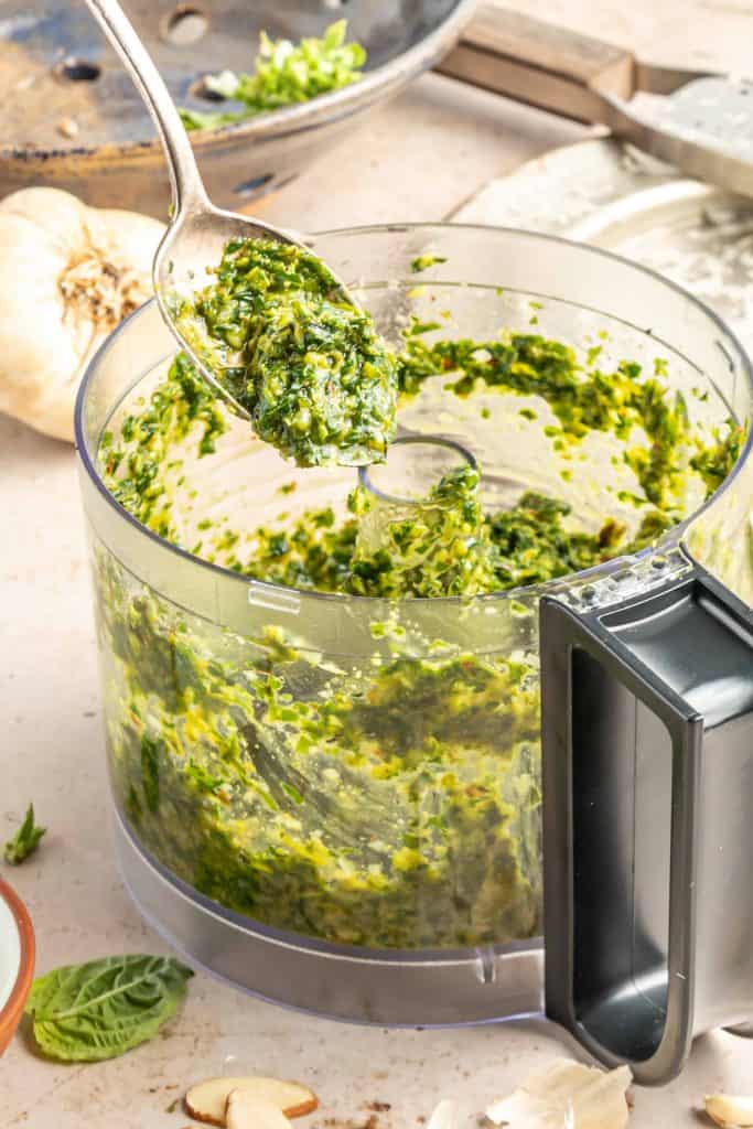 Pesto in food processor bowl.
