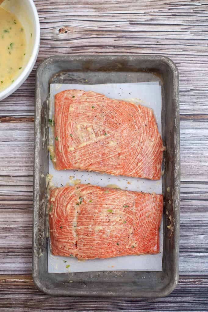 Salmon in pan with olive oil rub