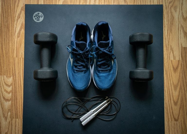 Overhead view of sneakers and weights.