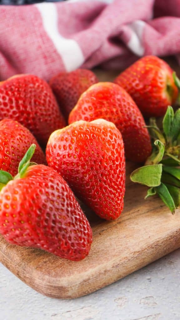 Strawberries on a cutting board.