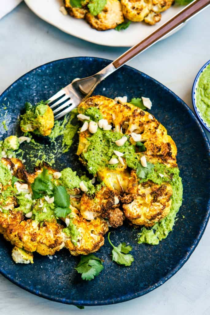Overhead view of cauliflower steak with pesto
