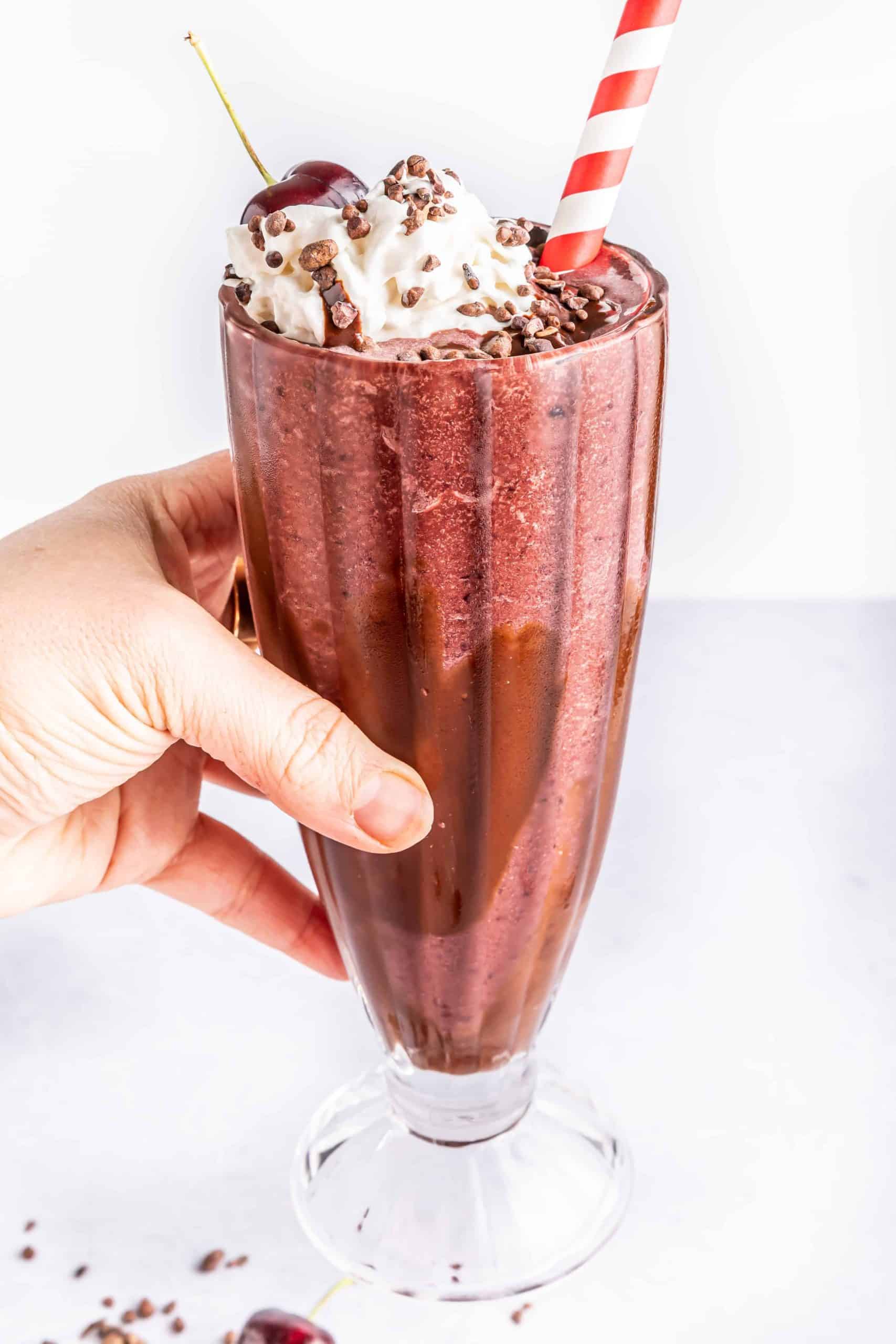 Chocolate Covered Cherry Milkshake in a tall glass.