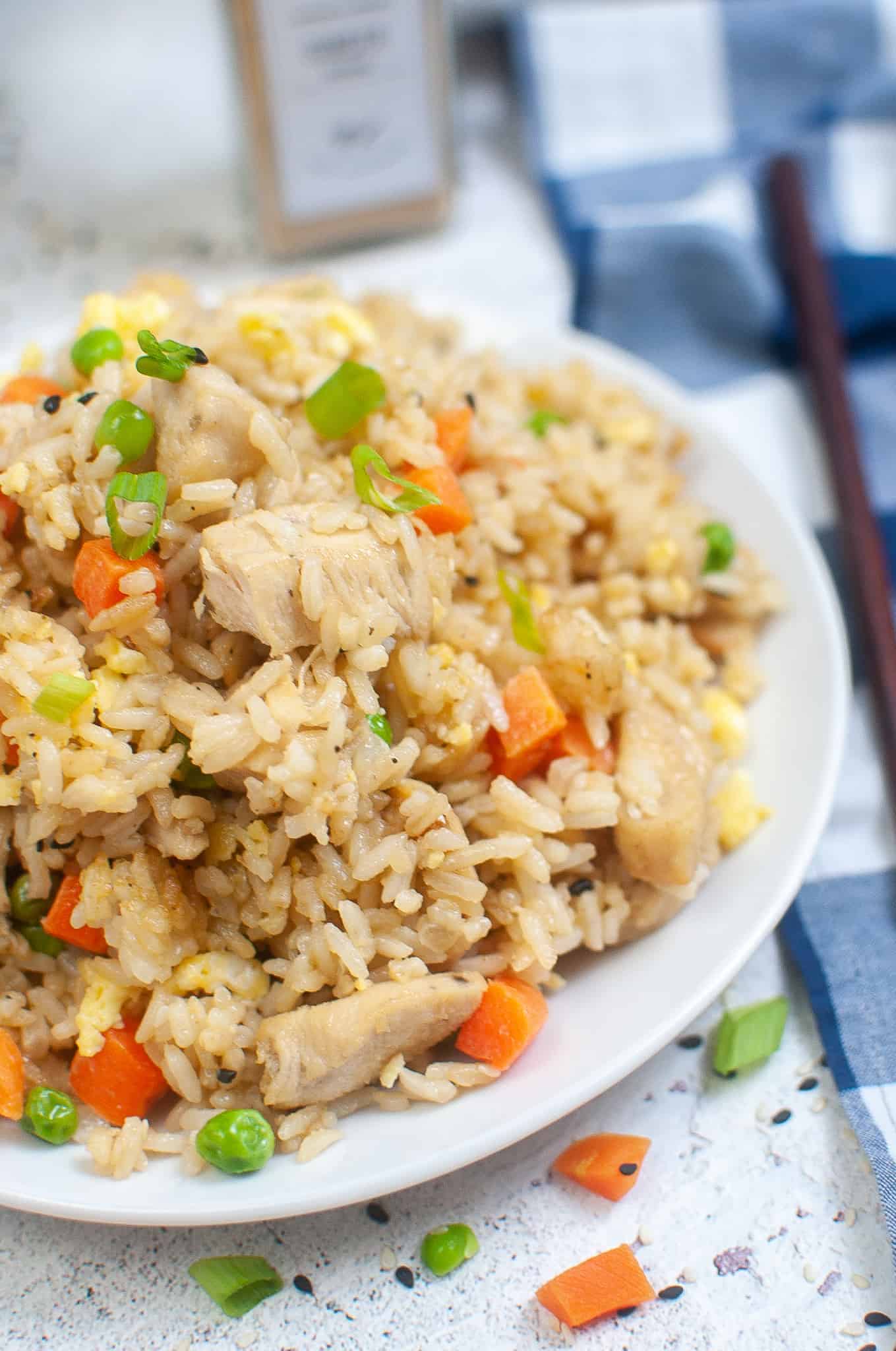 Closeup of Fried Rice with chicken and vegatables on a plate.