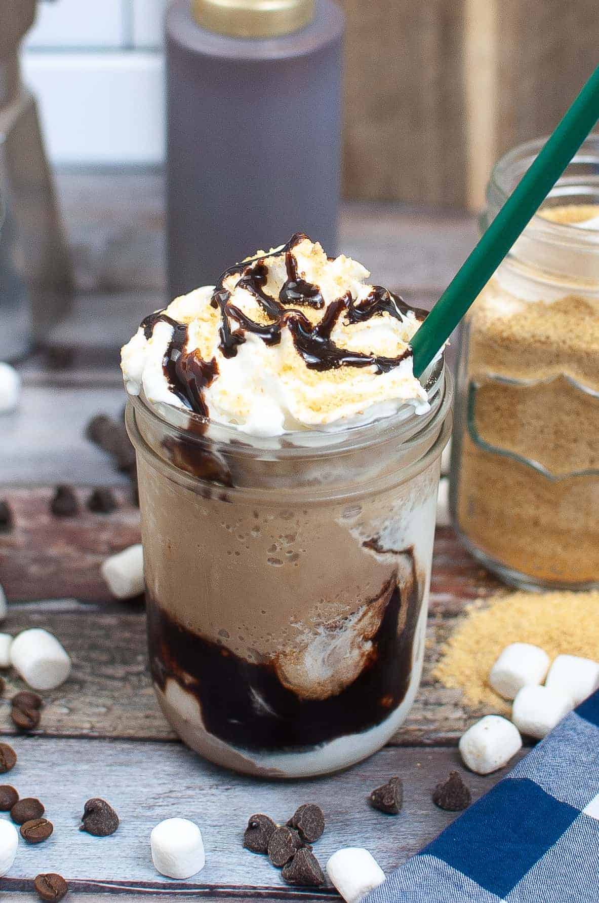 Coffee dessert drink in Mason jar with a green straw.