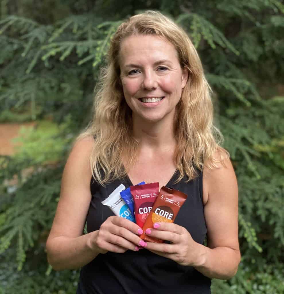 A woman holding a variety of Core Nutrition Bars.