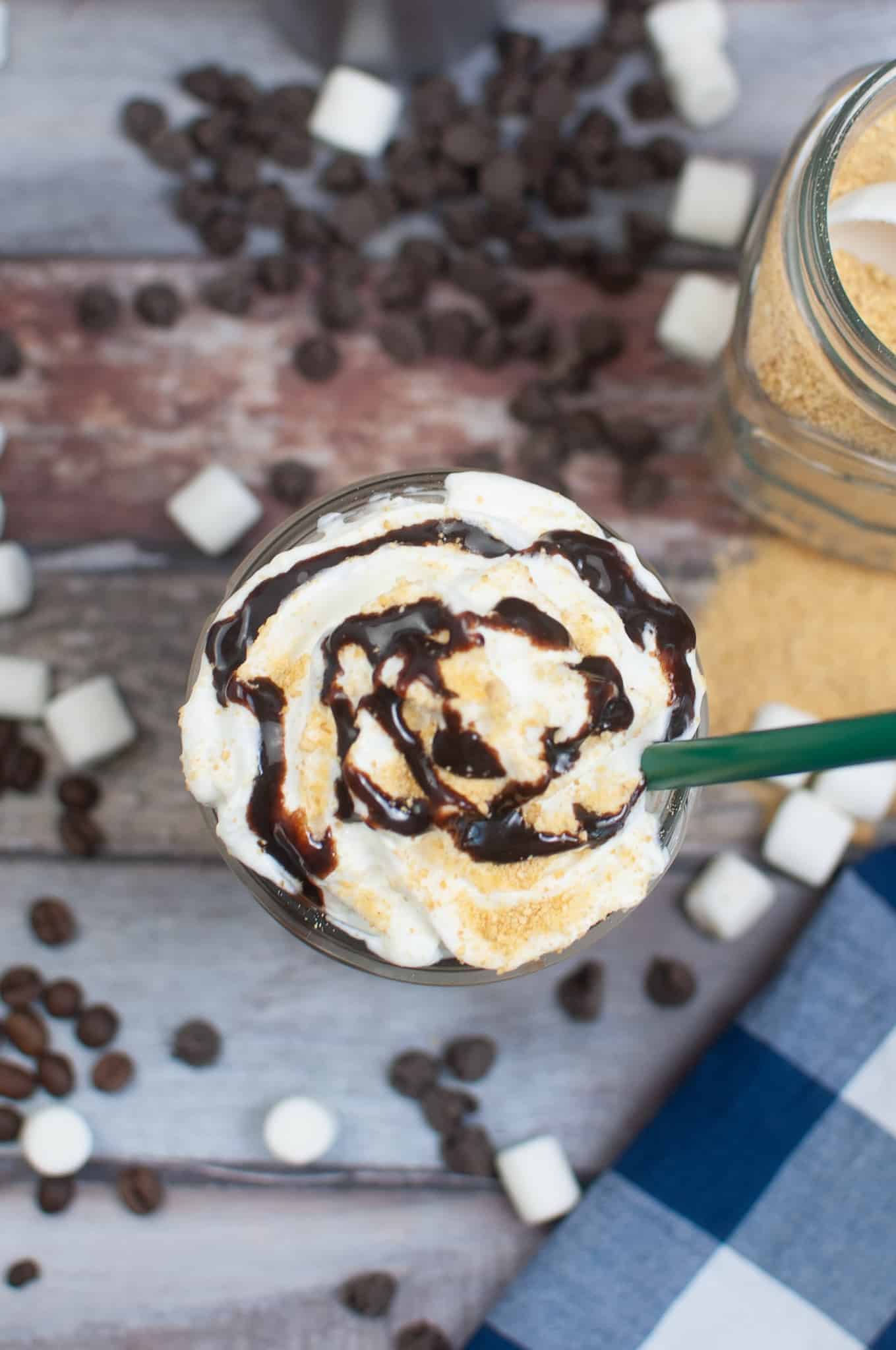 Overhead view of Smores frappuccino with whipped cream and chocolate syrup.