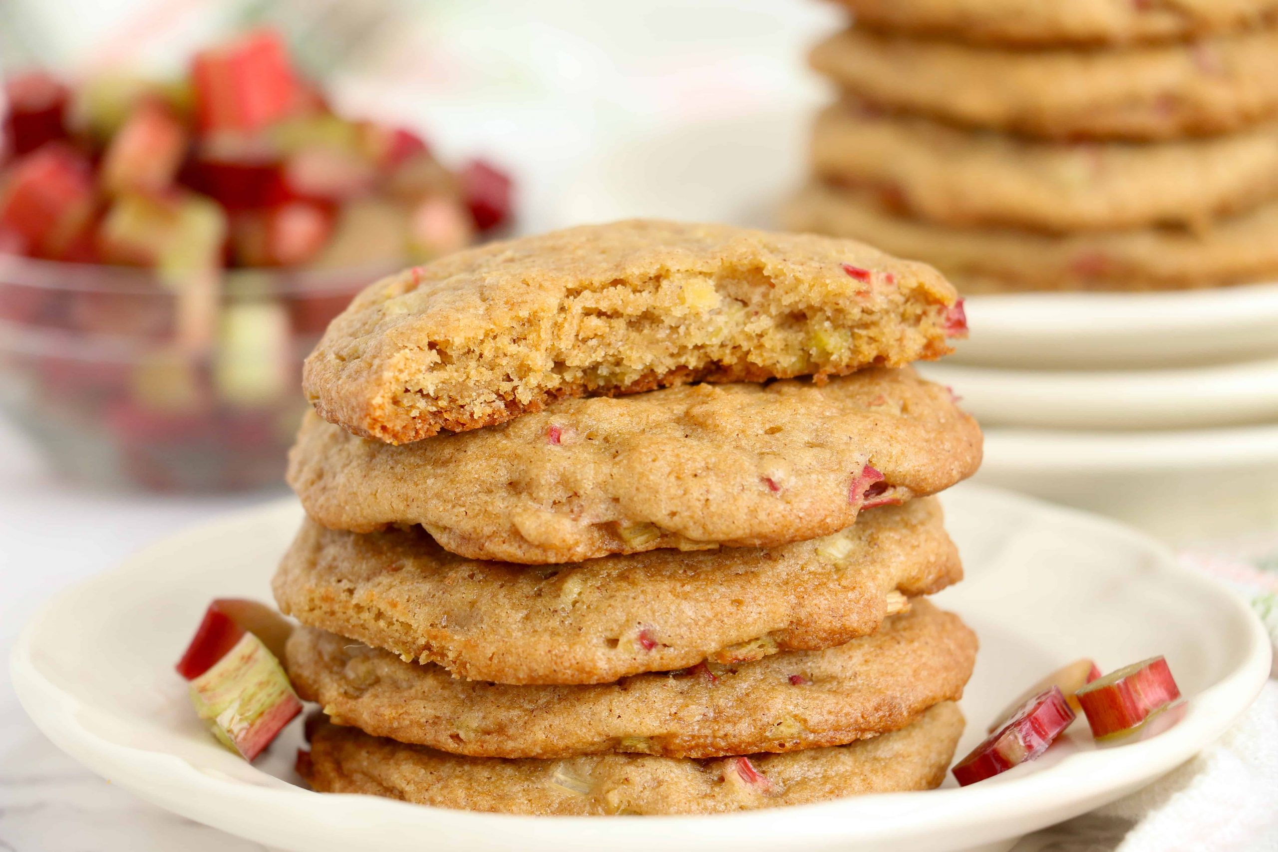 Stack of rhubarb cookies with a bite out of the one on top.