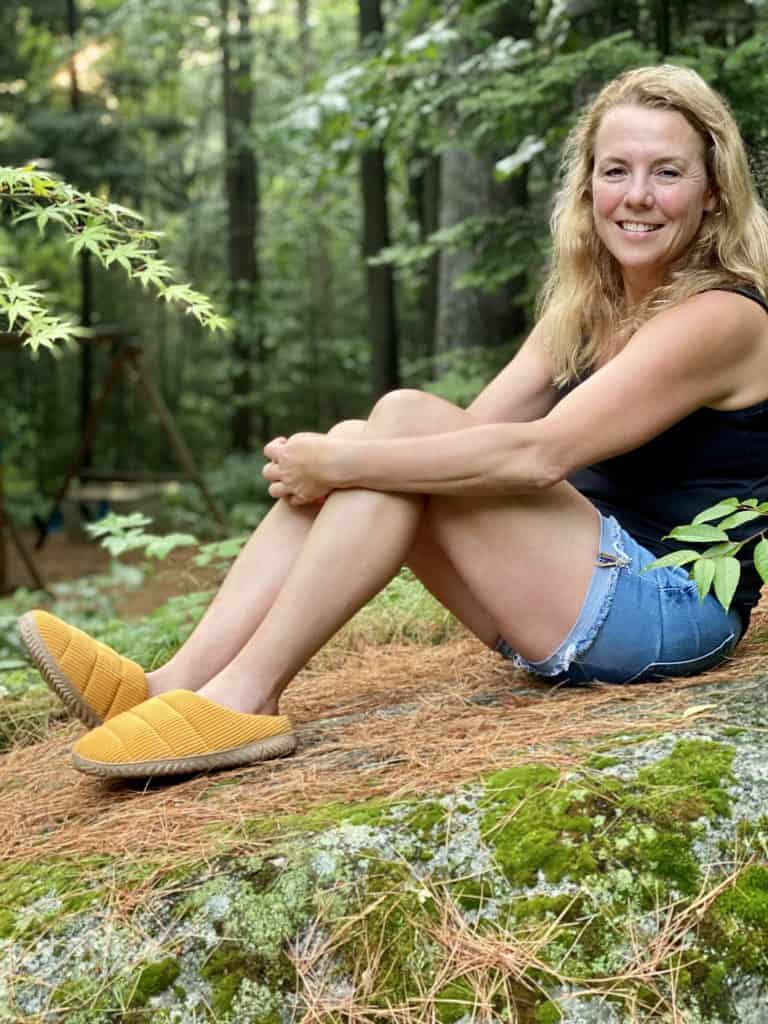 Woman wearing Staheekum honey gold slippers.