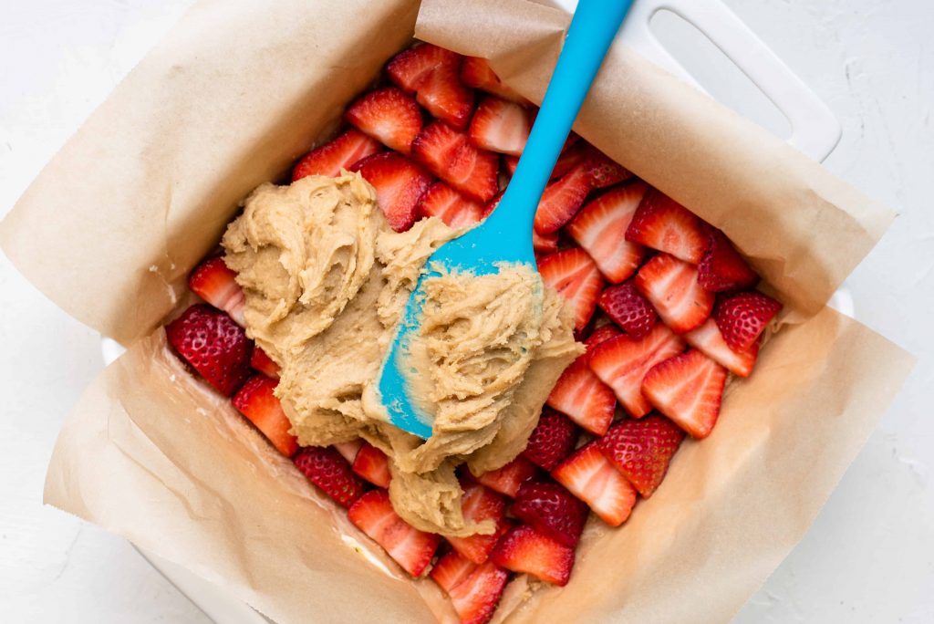 Batter on top of sliced strawberries