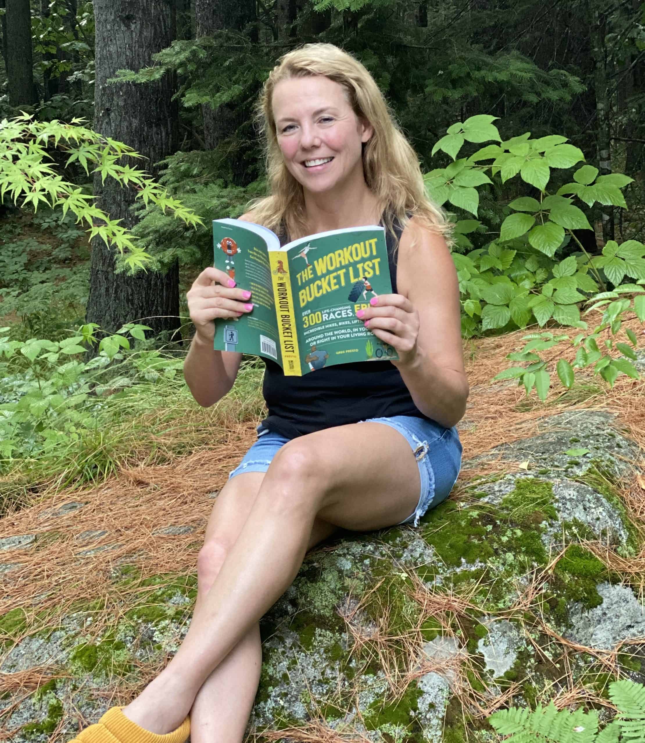 Woman holding The Workout Bucket List Book.