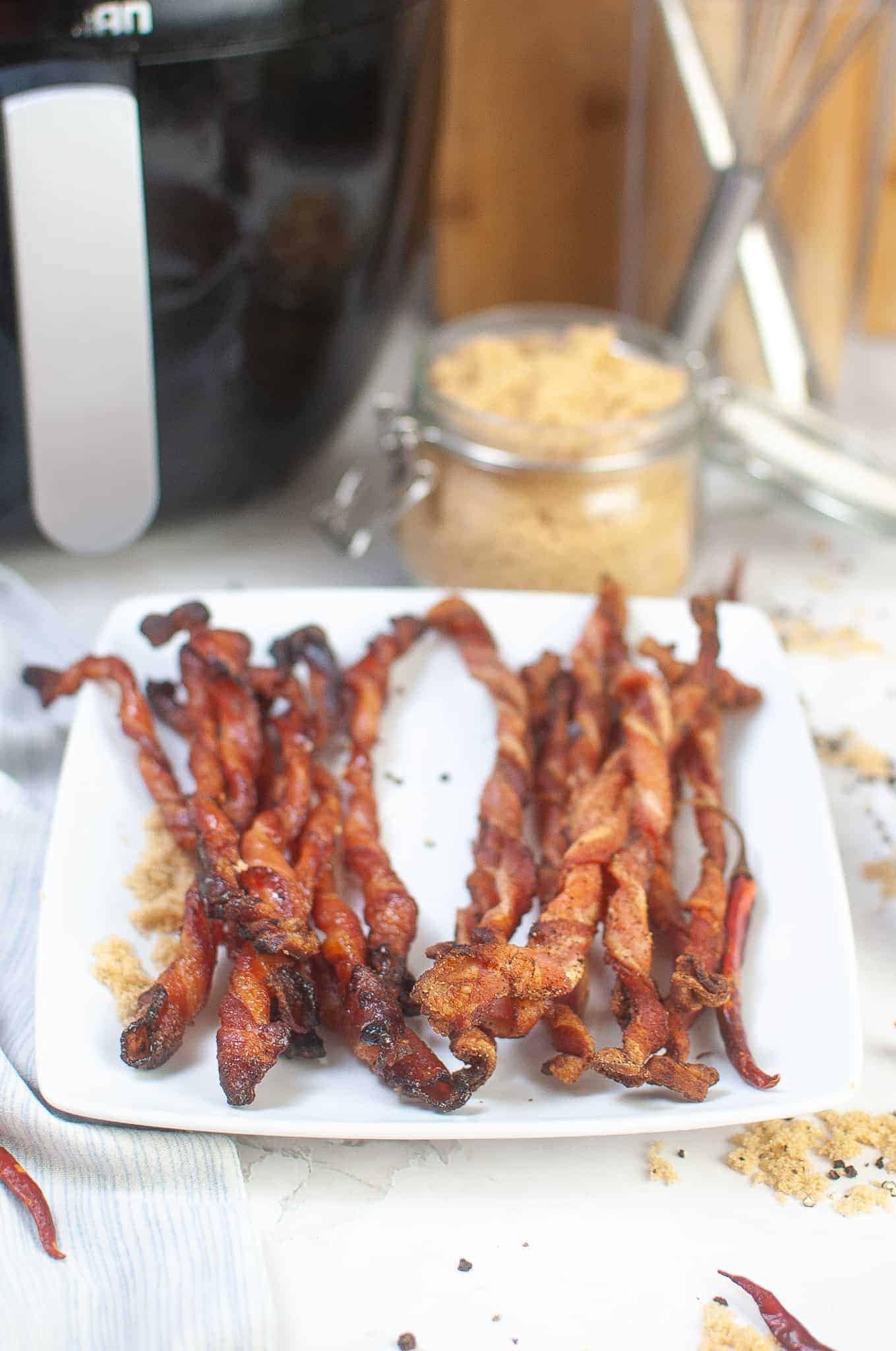 Air fryer twisted bacon on white plate.