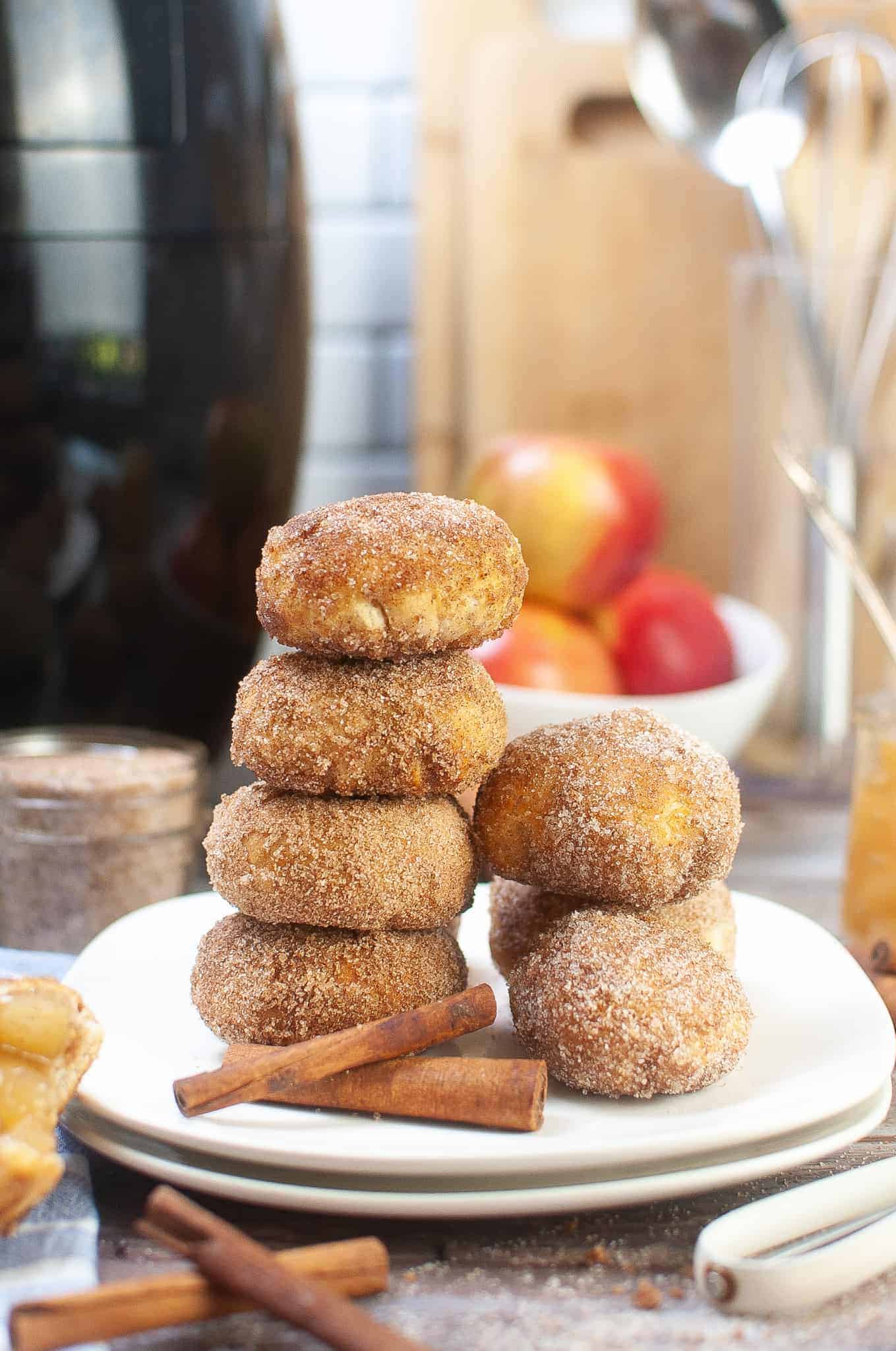 Apple Pie Bites stacked on a white plate.