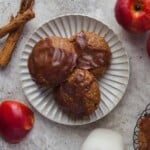 Overehead view of apple pie filled cookies on a white plate.