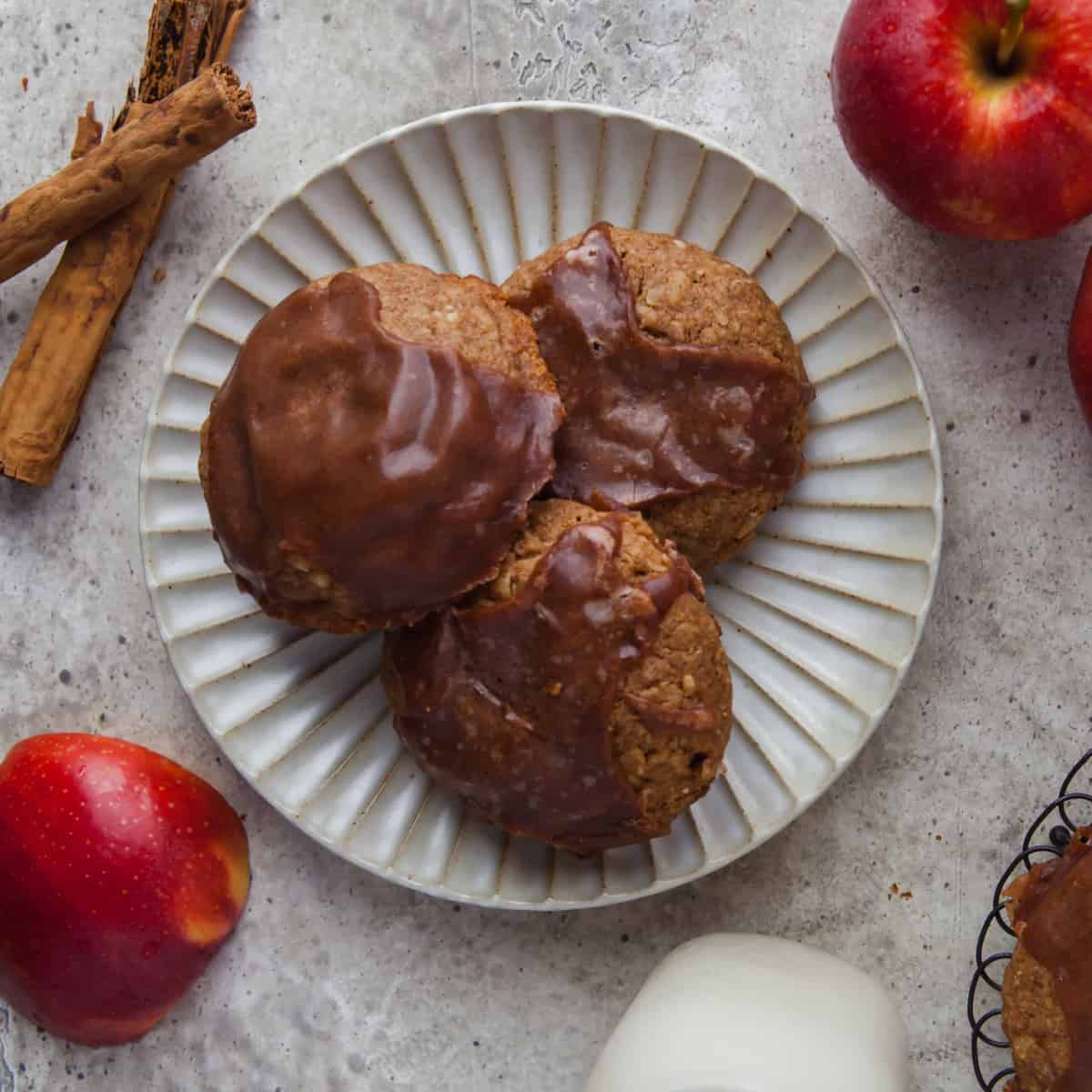 Overehead view of apple pie filled cookies on a white plate.