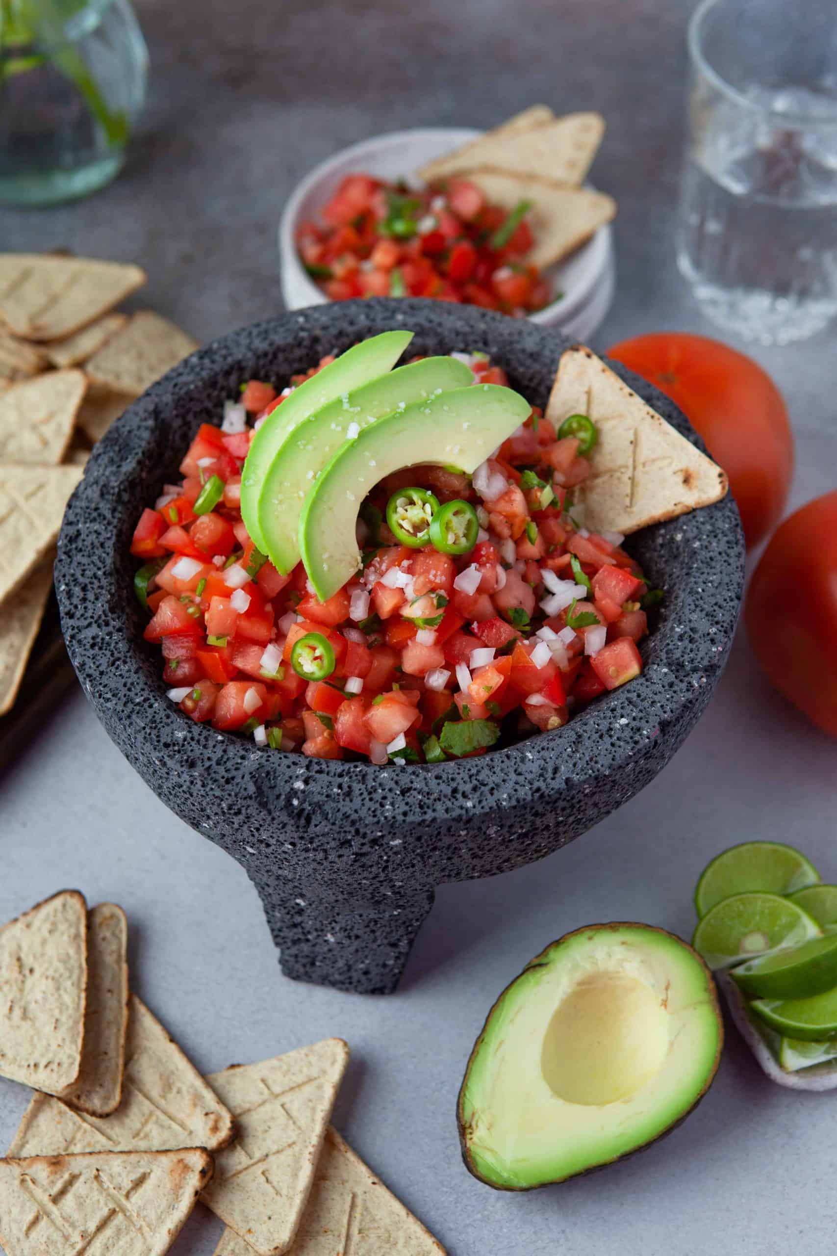 Authentic Salsa Fresca in a bowl with thinly sliced avocado.