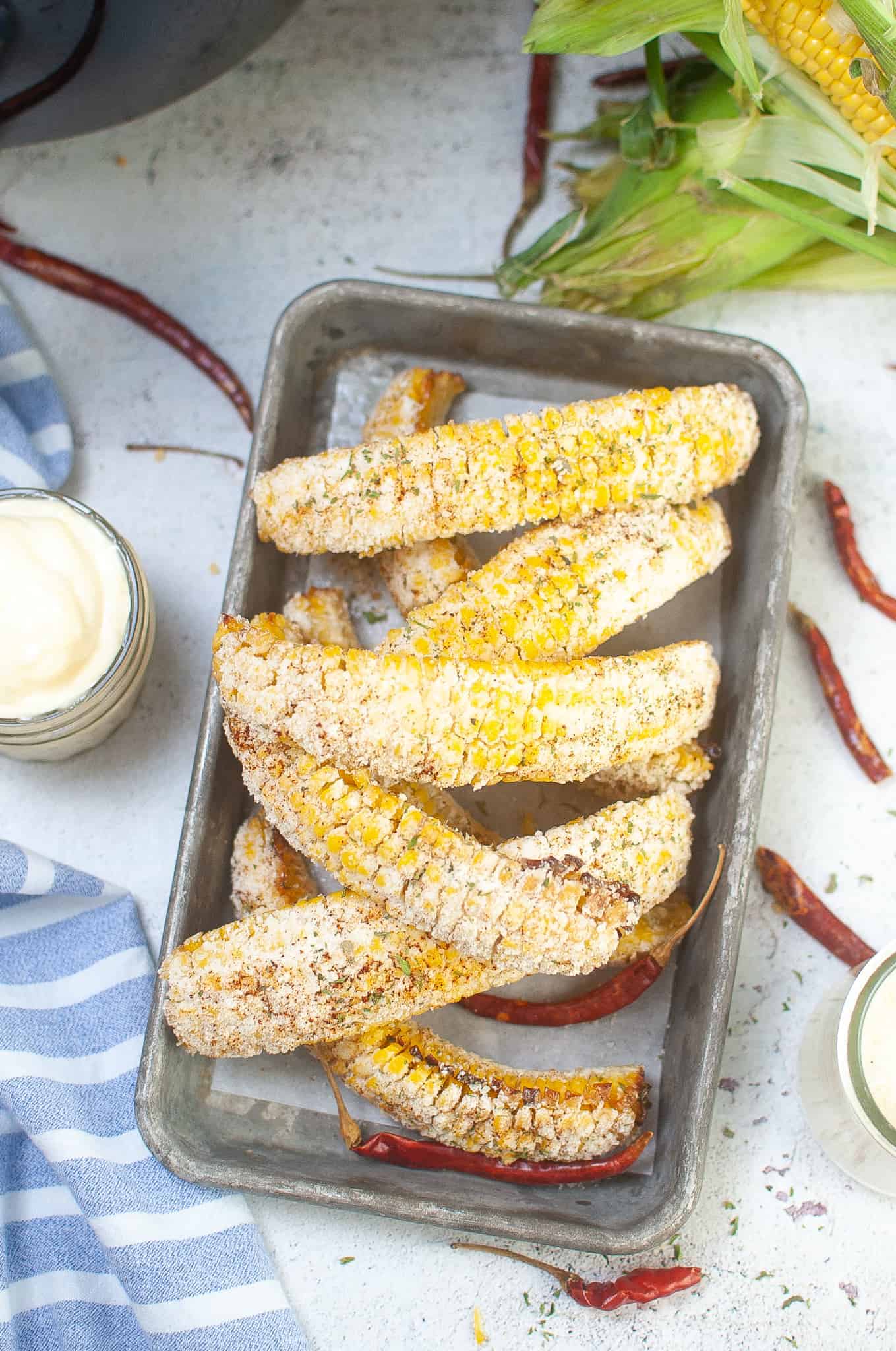 Overhead view of corn ribs on a metal tray.