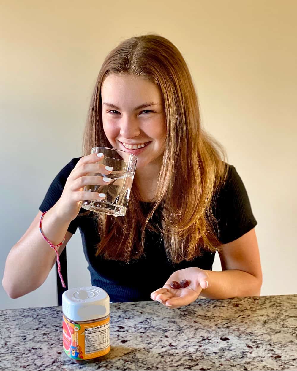 Girl taking supplement with Wellmune.