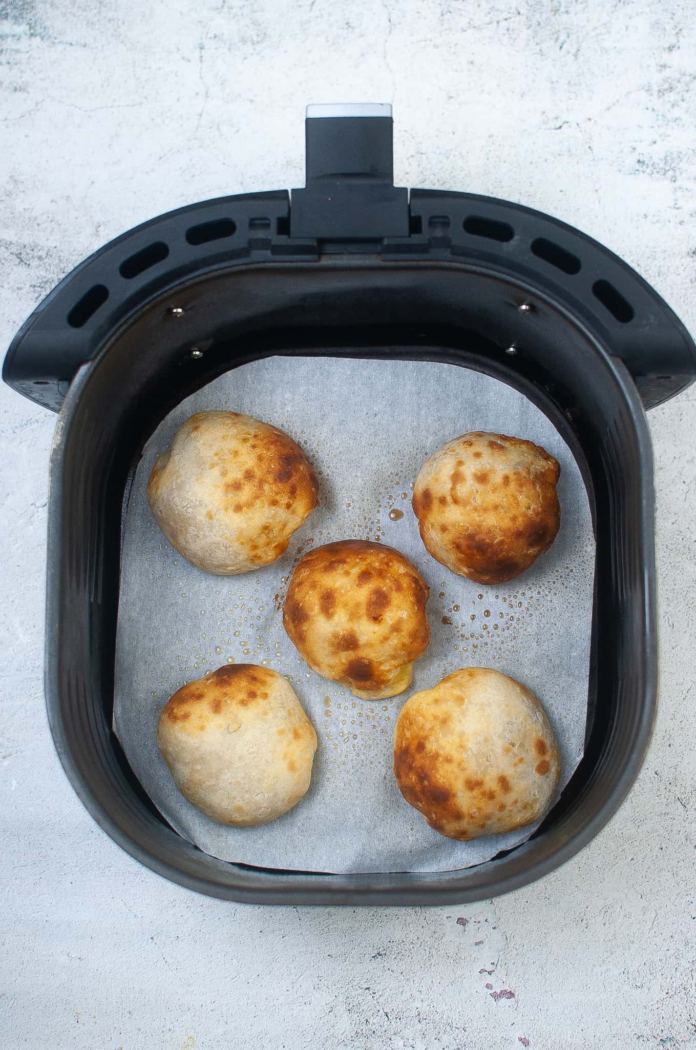 Overhead view of Pumpkin Pie Bombs in Air Fryer Basket.