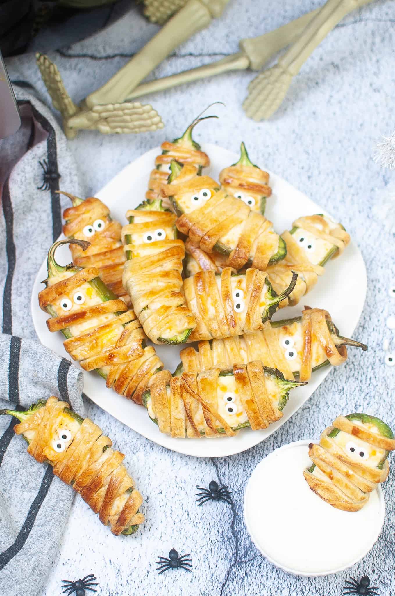 Overhead view of jalapeno popper mummy on a white plate.