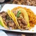 Air Fryer Carnitas Tacos on a white plate with rice.