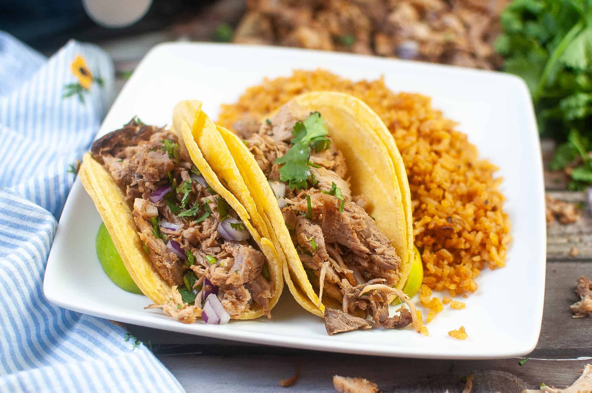 Air Fryer Carnitas Tacos on a white plate with rice.