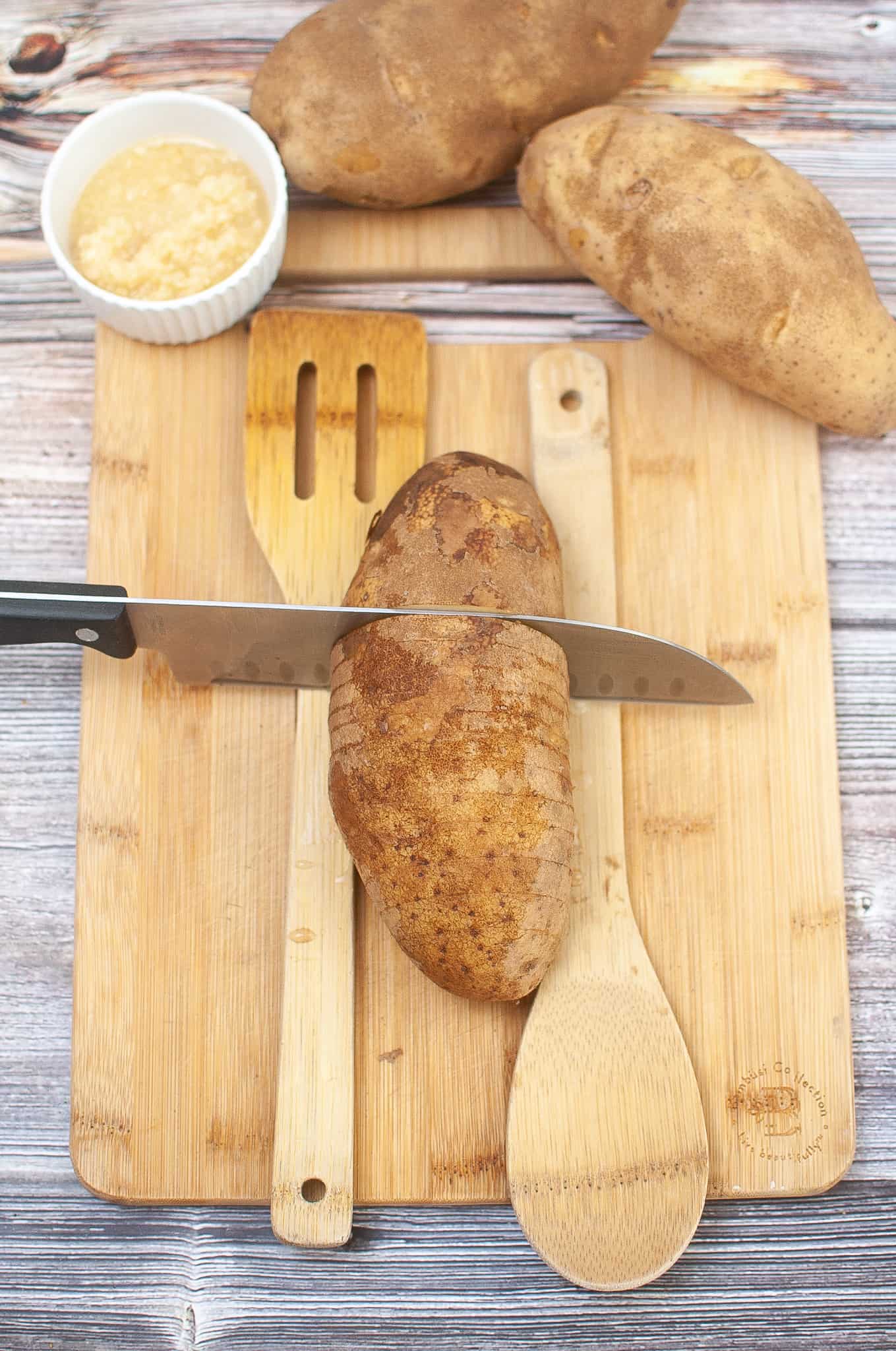 Overhead view of cutting potato hasselback style.