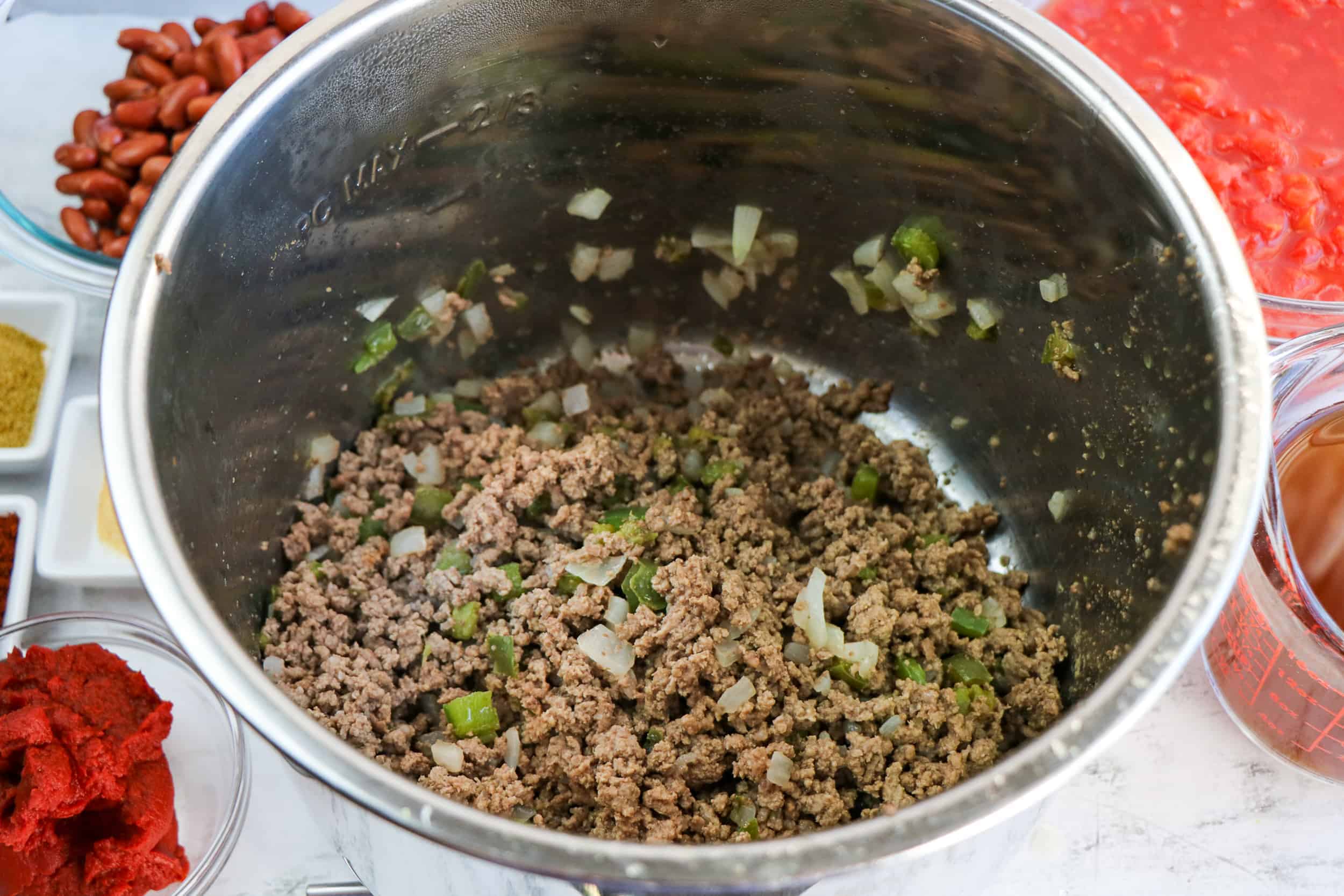 Ground beef, diced bell pepper and onion in Instant Pot.