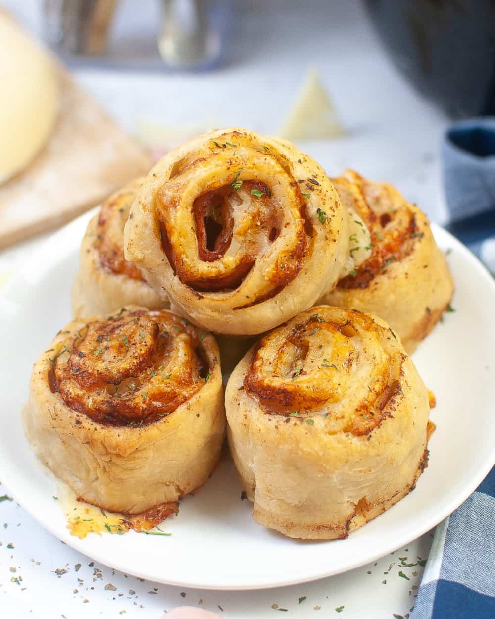 Ham and Swiss cheese pinwheels on a white plate.