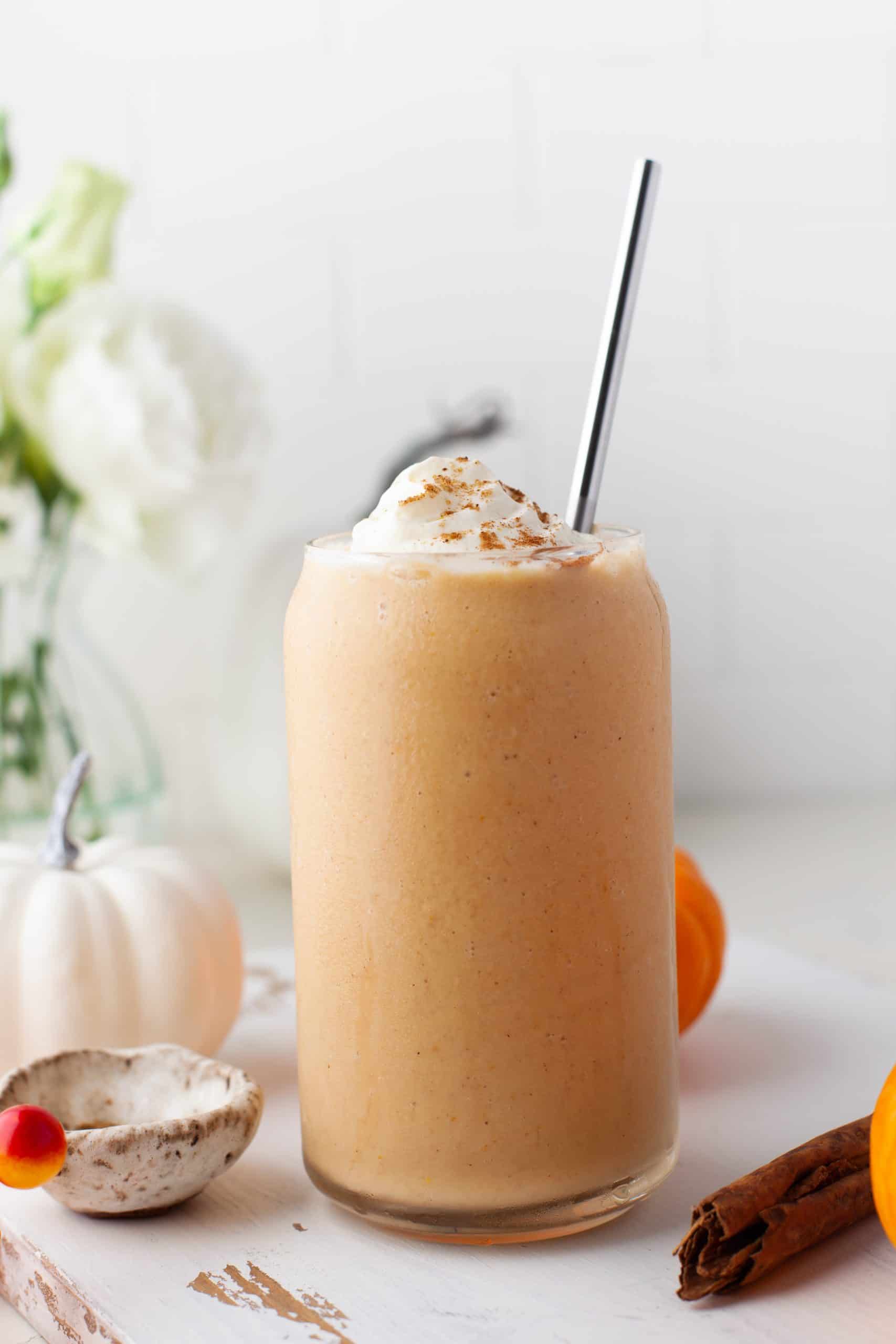 Pumpkin Pie Smoothie with a metal straw in it.