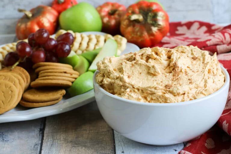 Bowl of pumpkin whip with fruit and cookie tray.