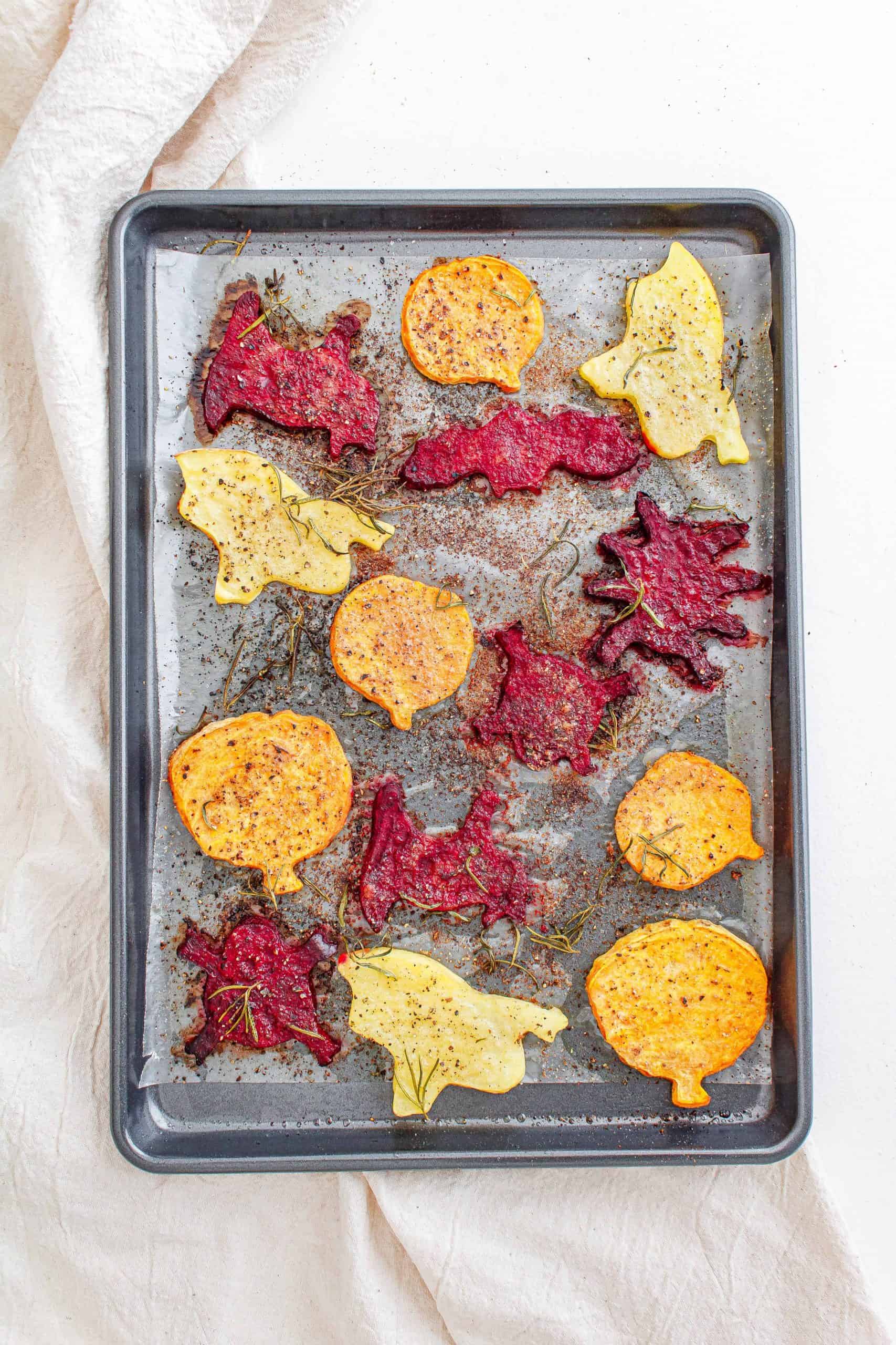 Roasted Halloween vegetables on a sheet pan, overhead view.