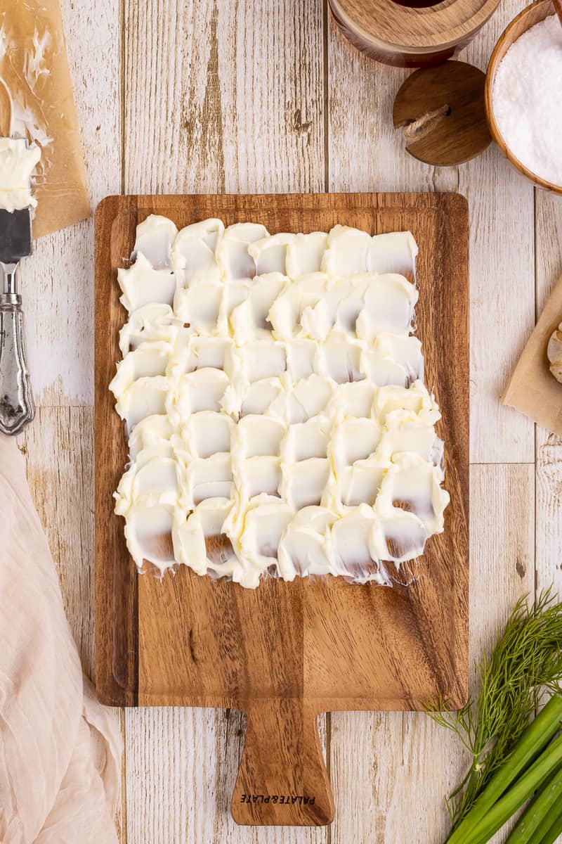 Creating a beautiful pattern with butter on a cutting board.
