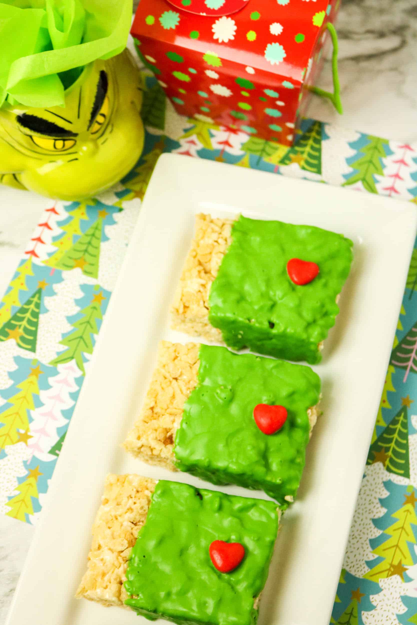 Overhead view of Rice Krispies Treats with green chcoloate and red candy hearts.
