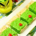Grinch Rice Krispies Treats lined up on a platter.