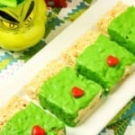 Grinch Rice Krispies Treats lined up on a platter.