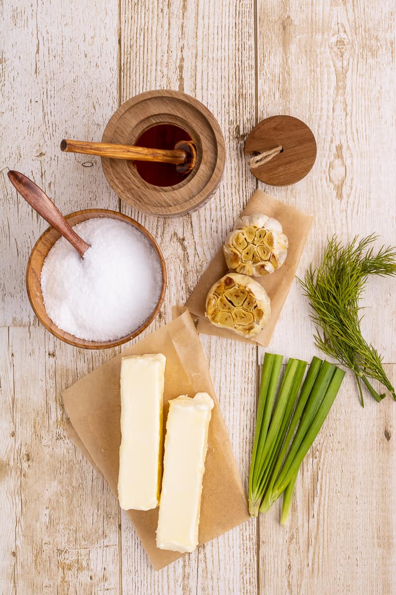 Ingredients needed to make a butter board with garlic and honey.