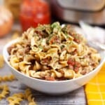 Bowl of pasta with meat and tomato sauce.