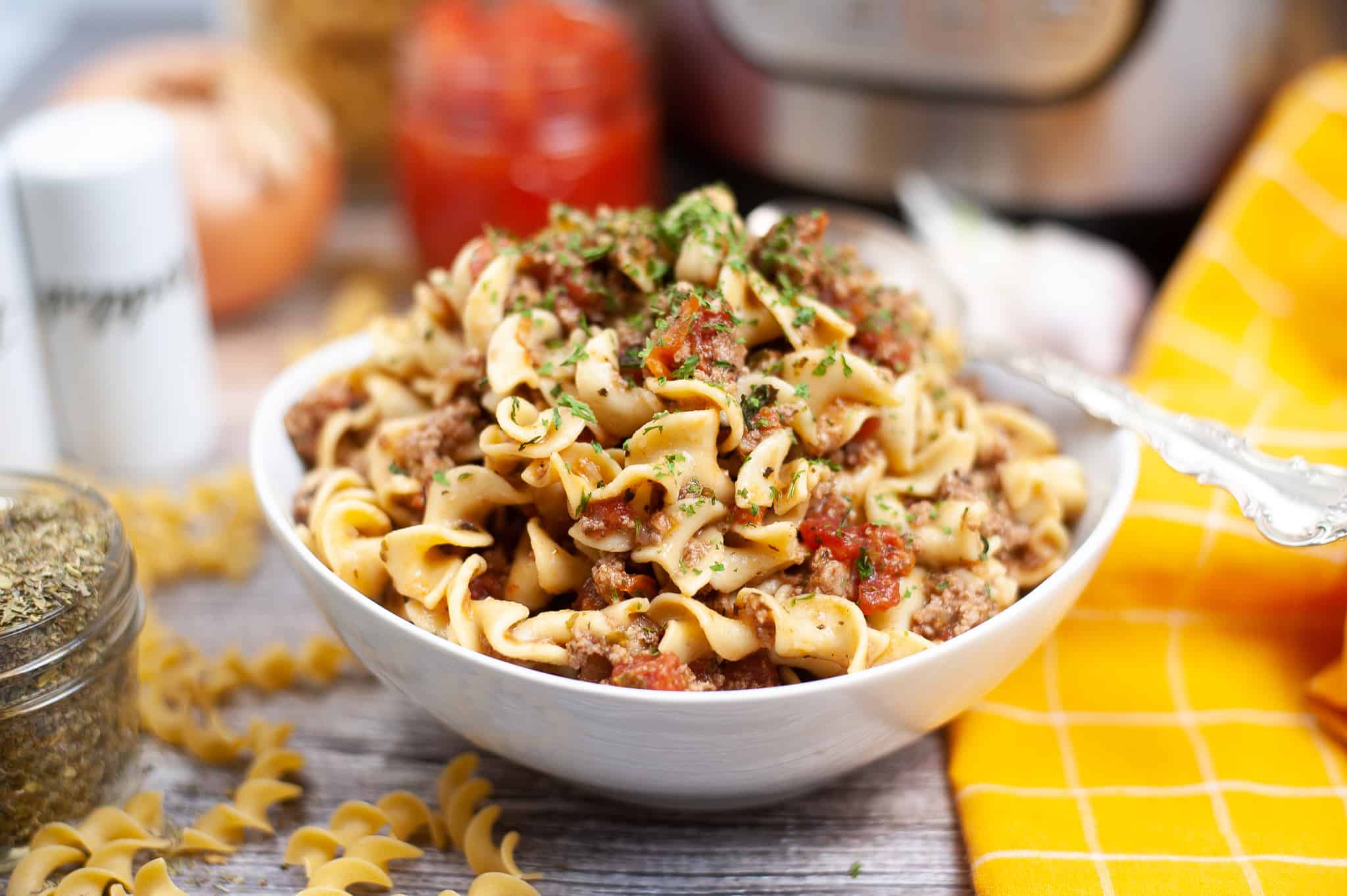 Bowl of pasta with meat and tomato sauce.
