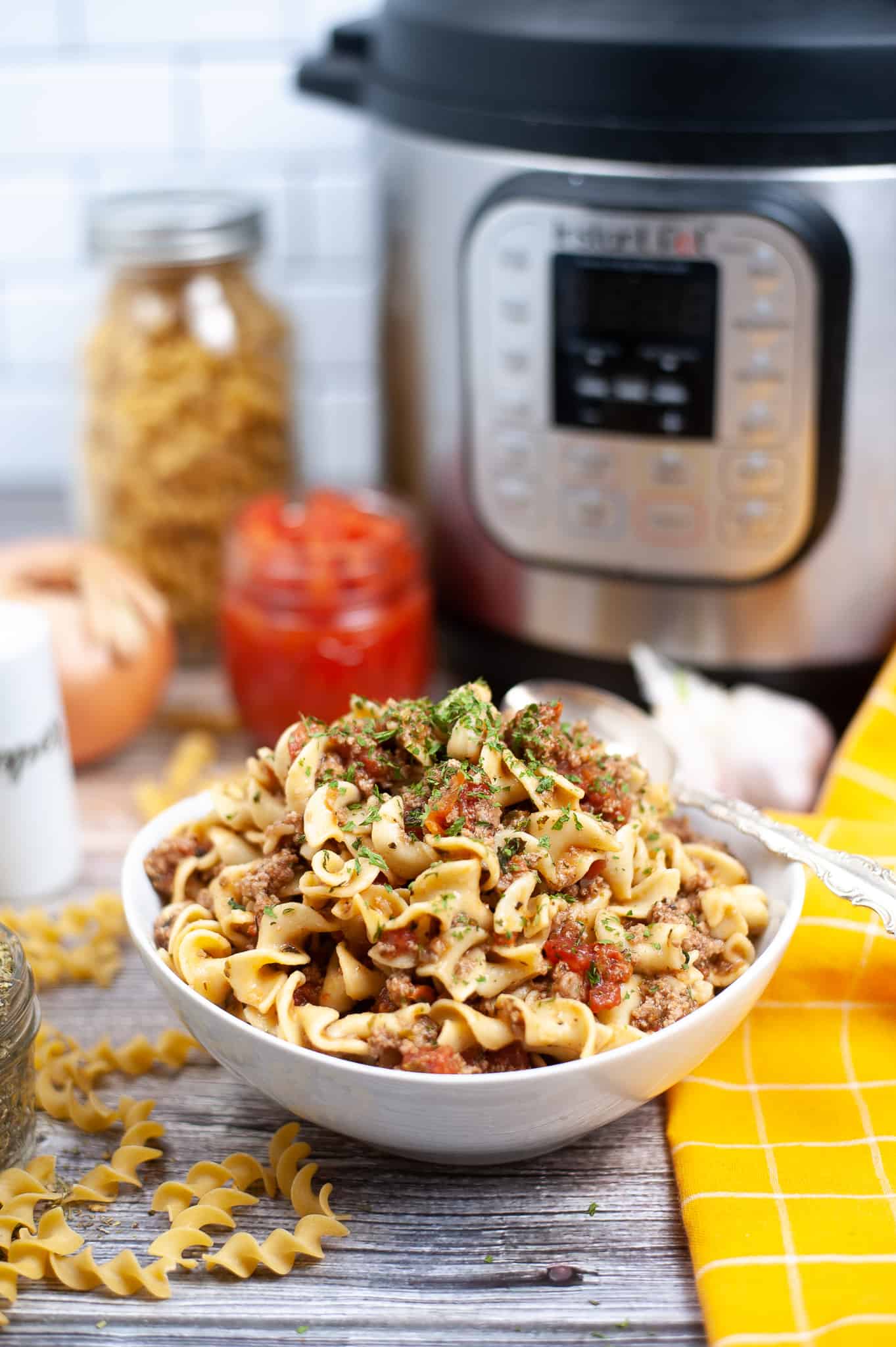 Bowl of Instant Pot Goulash with parsleys sprinkled on top.