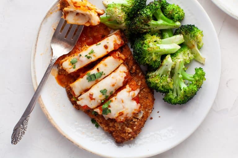 Overhead photo of chicken cut into slices with broccoli on the side.