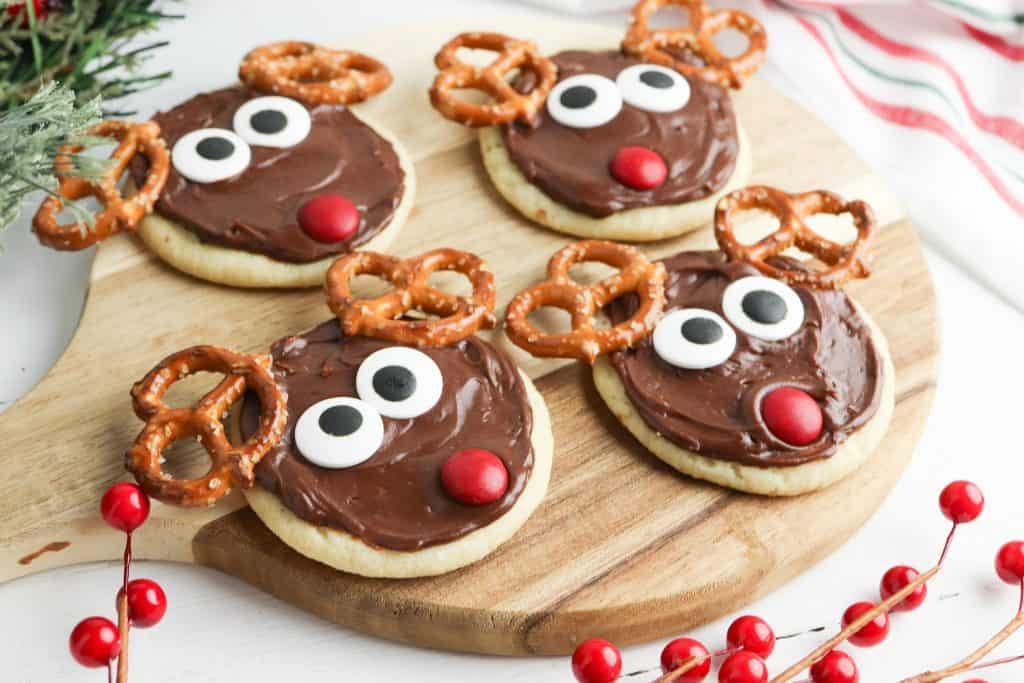 Reindeer cookies on a cutting board.