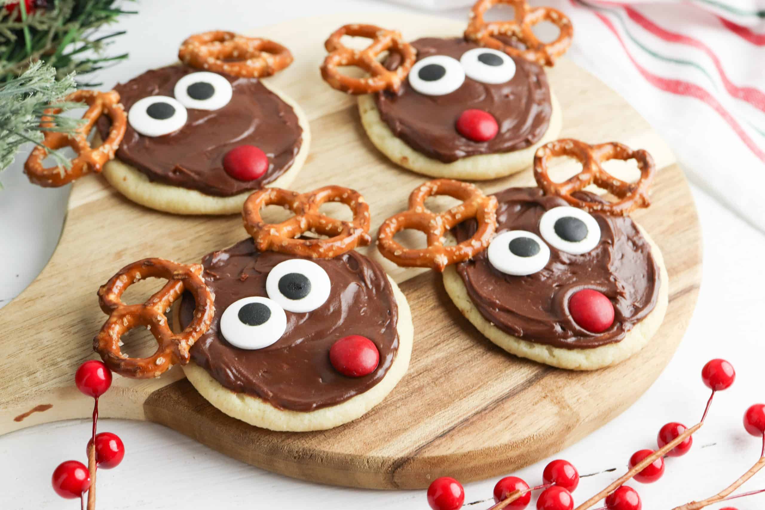Reindeer cookies on a cutting board.
