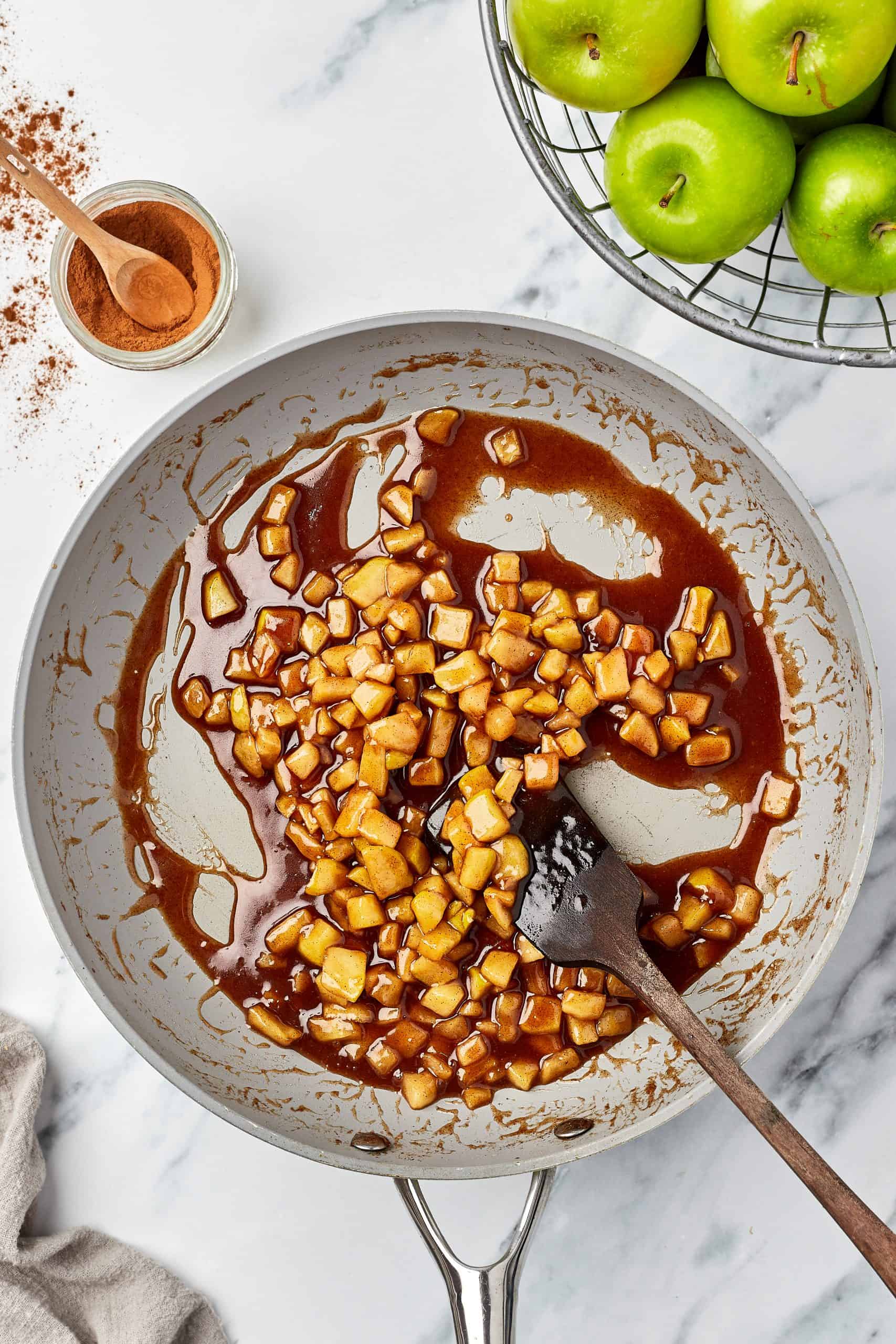 Cooked apples in a skillet.