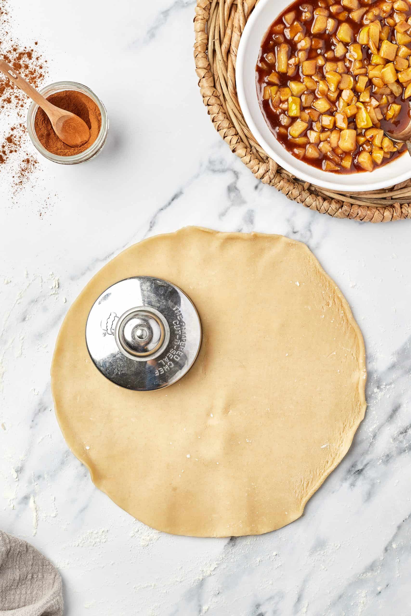 Pressing dough circles with a hamburger press.